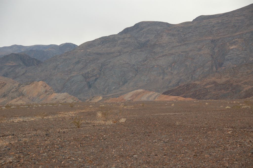 While on the dark rock, we continued aiming for the small hillside seen in the center distance: